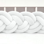 Close-up of a white braided knot on a white background