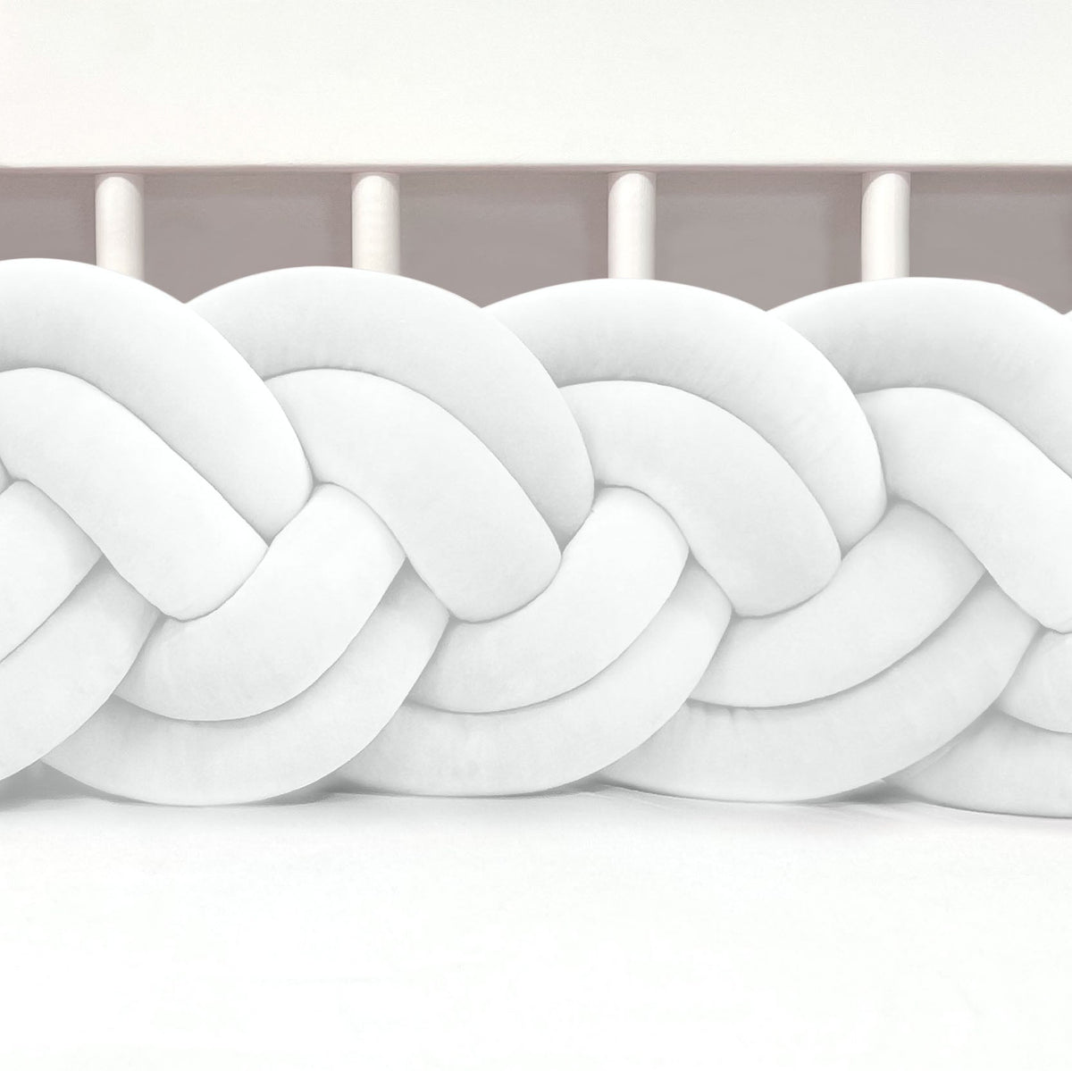 Close-up of a white braided knot on a white background