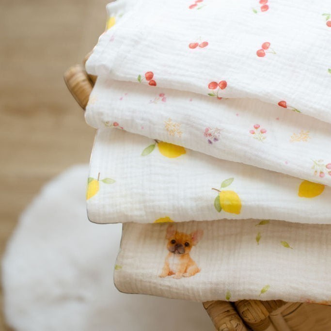 Baby NaturHere maxi muslin swaddle blankets with cherry, lemon, and French bulldog prints. 100% cotton.