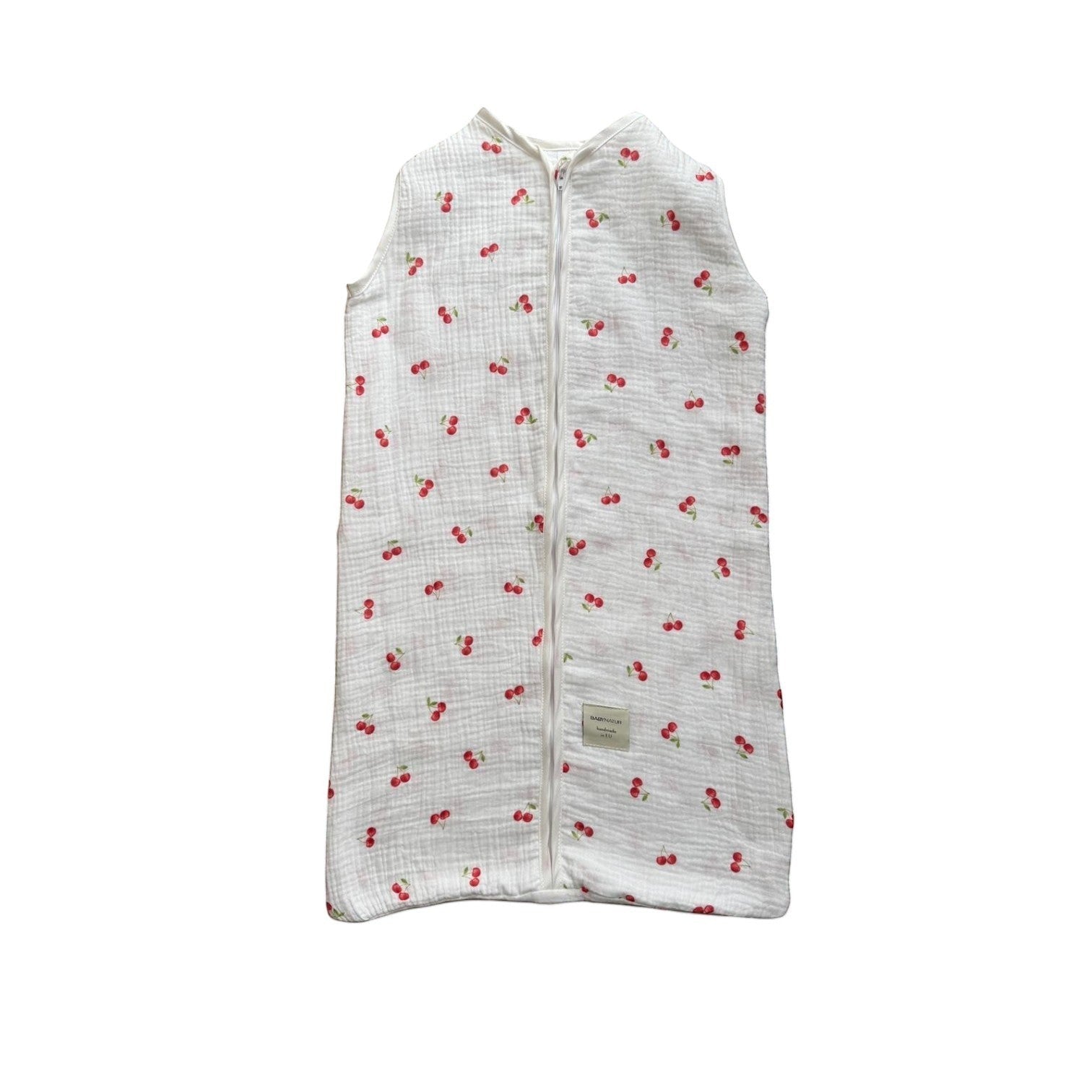 Baby Natur sleeveless sleeping bag with a white background and red cherry print. Made from soft, breathable cotton.