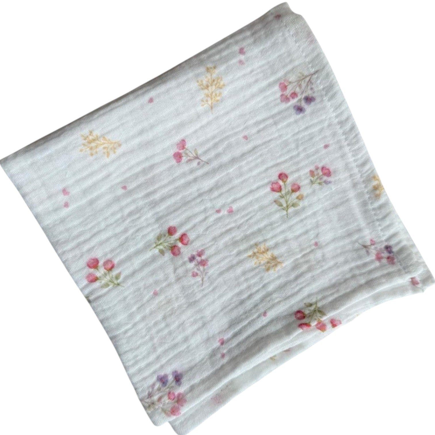 Baby Natur white cotton muslin swaddle blanket with a delicate floral print of pink and purple flowers and yellow accents.