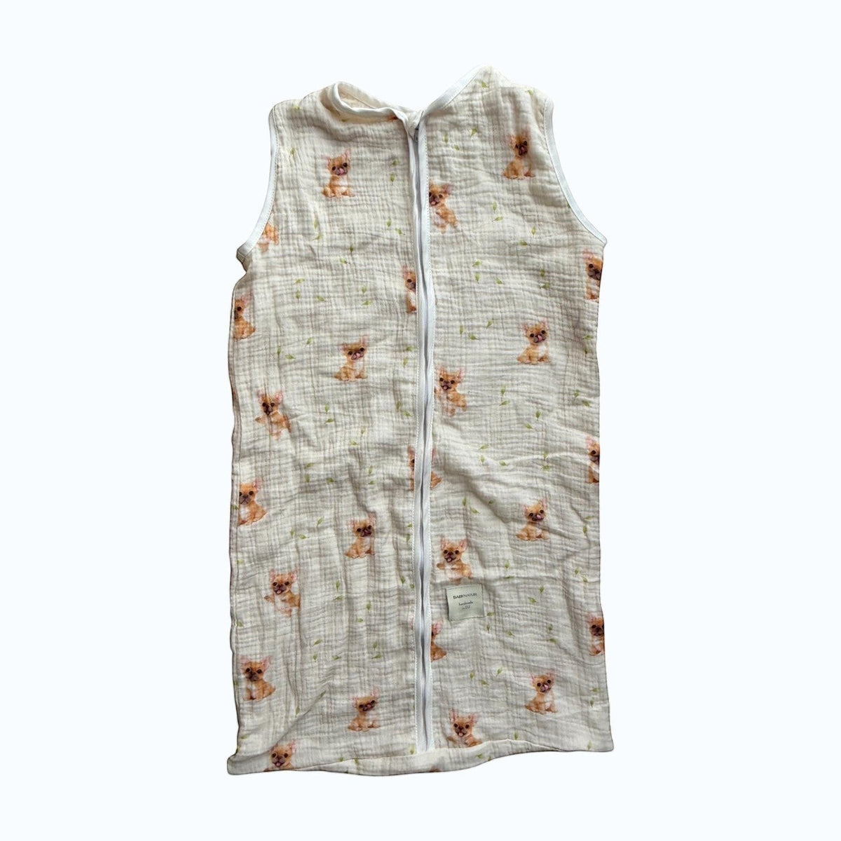 Baby Natur sleeveless sleeping bag with a cream background and a cute chihuahua dog print. Made from soft, breathable cotton.