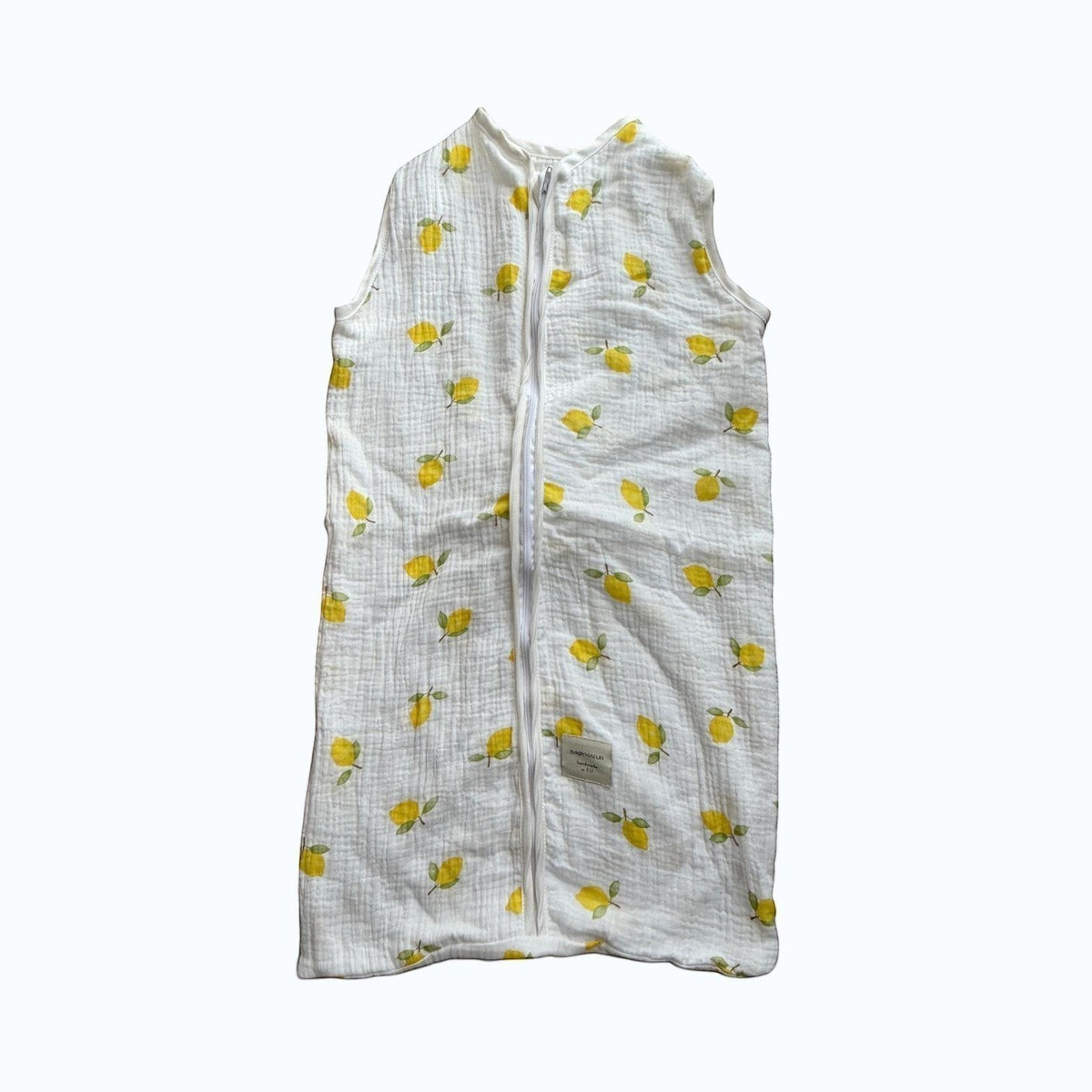 Baby Natur sleeveless sleeping bag with a white background and yellow lemon print. Made from soft, breathable cotton.