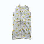 Baby Natur sleeveless sleeping bag with a white background and yellow lemon print. Made from soft, breathable cotton.