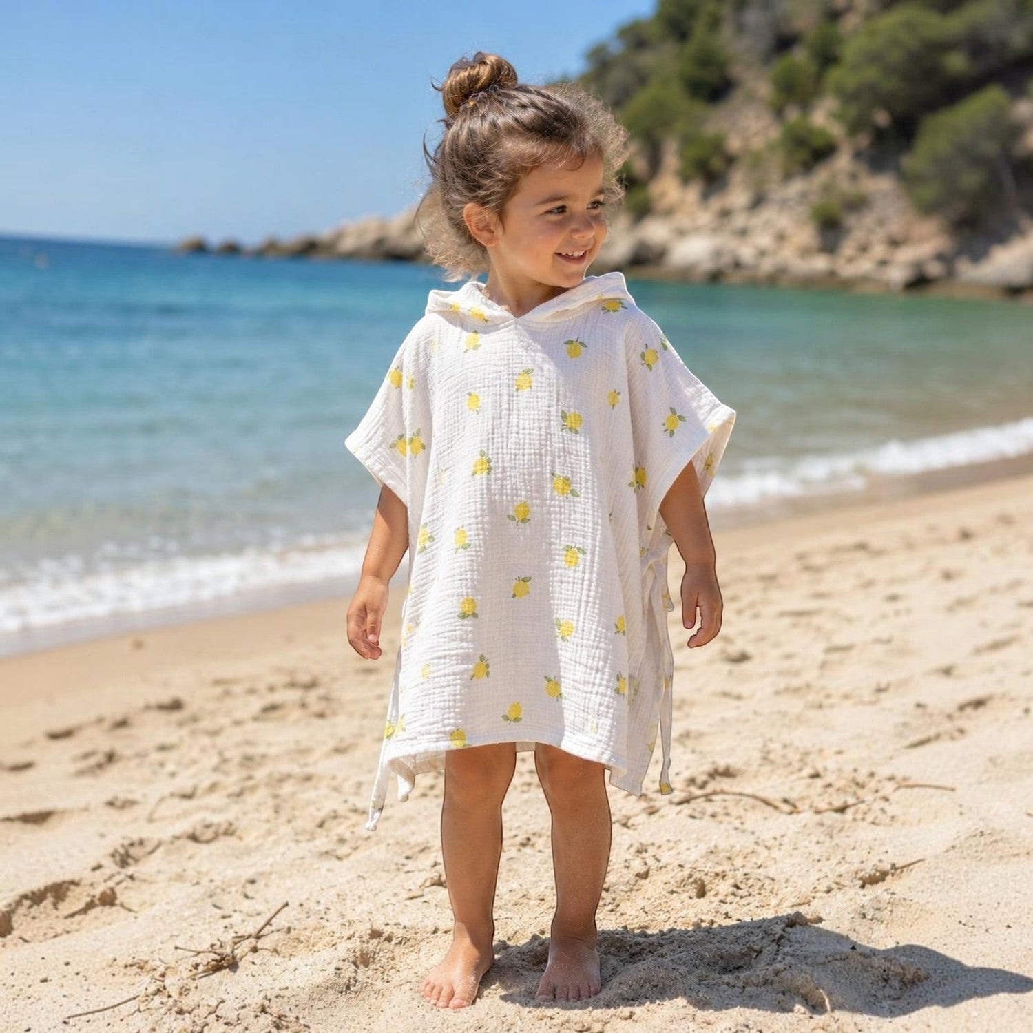 Baby Natur white muslin hooded poncho with yellow lemon print, for babies and children at the beach.