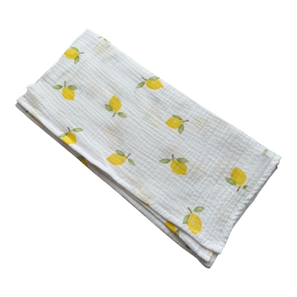 Baby NaturStandard tetra diaper with a white background and a pattern of yellow lemons and green leaves. 100% cotton.